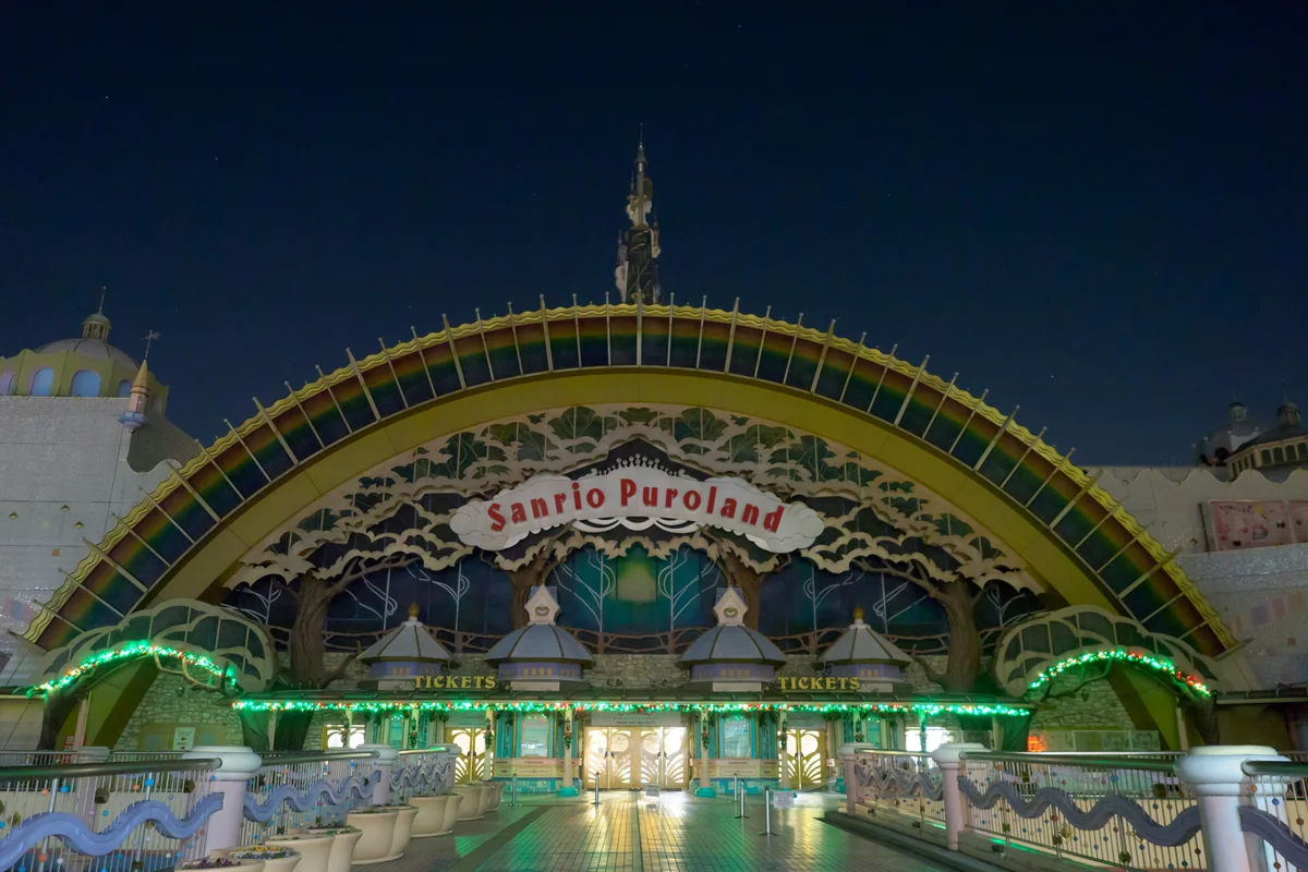 The rainbow-arched entrance of Sanrio Puroland lit up and empty after closing time