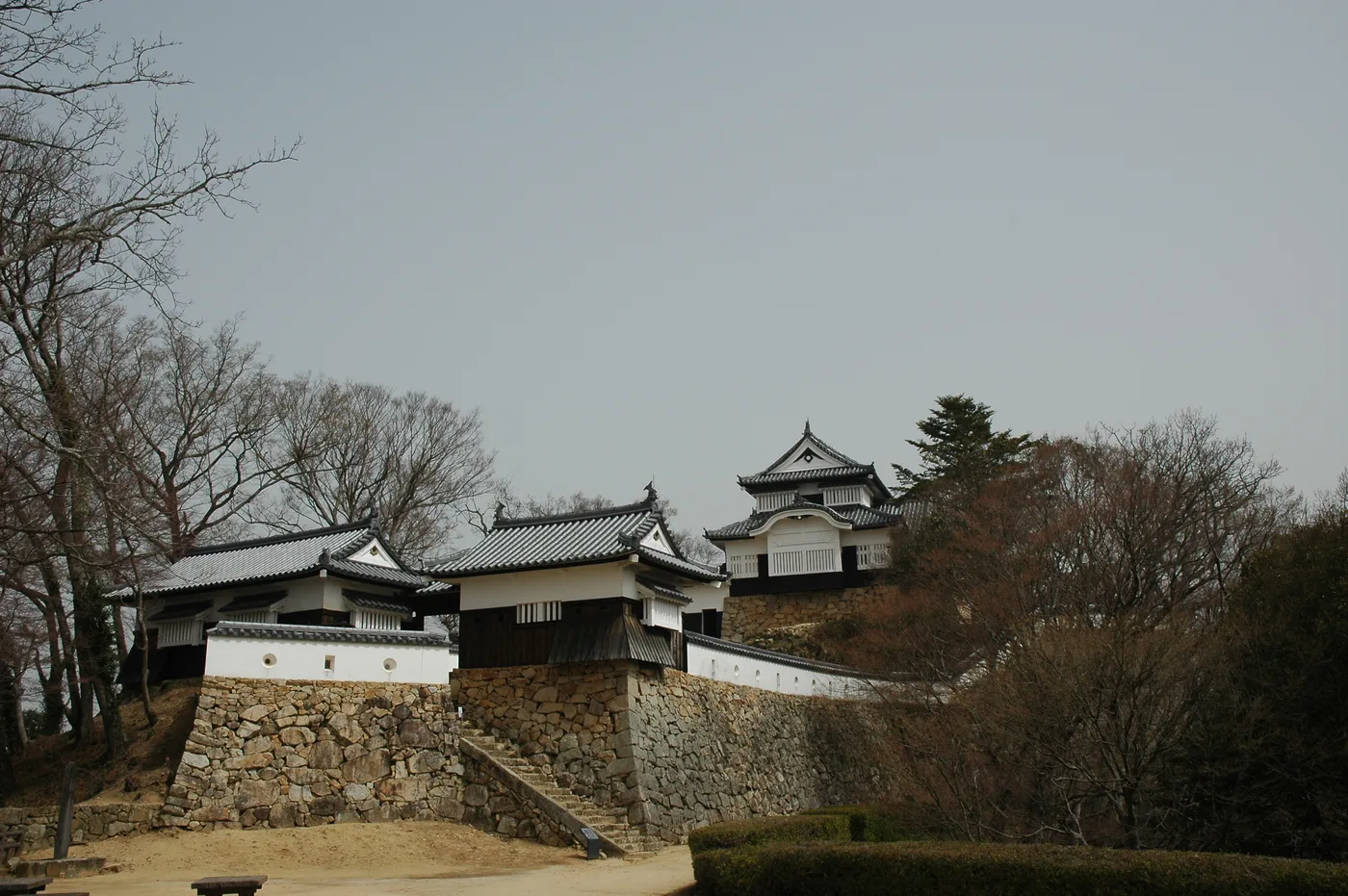 The small two-storey wooden keep of Bitchu-Matsuyama Castle, with white-walled turrets standing above rough stone walls