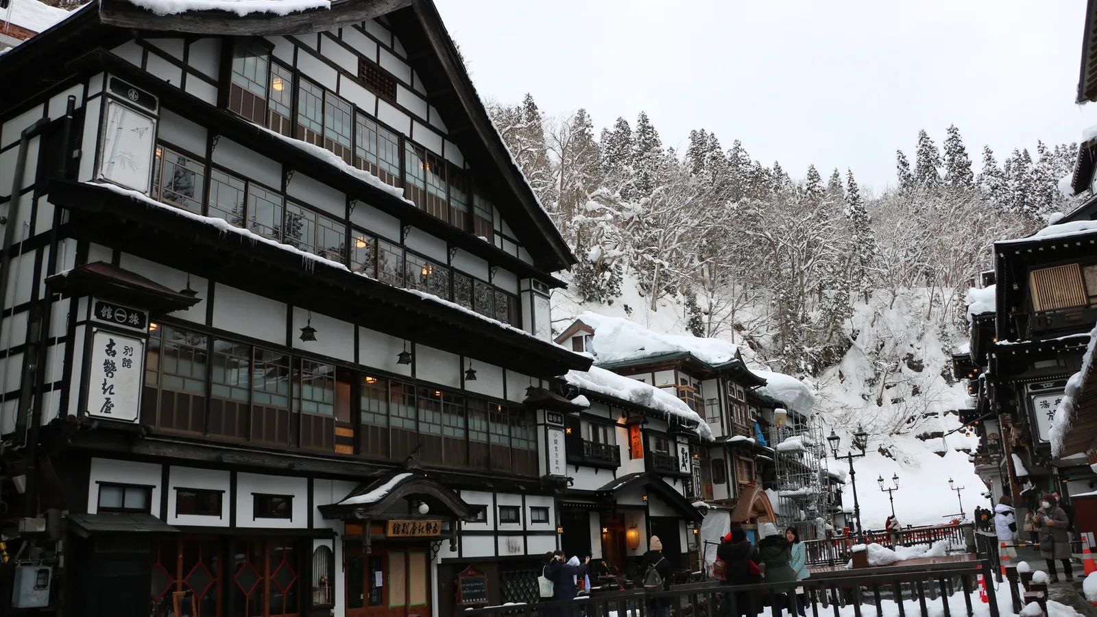 Tall wooden three- and four-storey inns facing each other across the Ginzan River in the centre of Ginzan Onsen