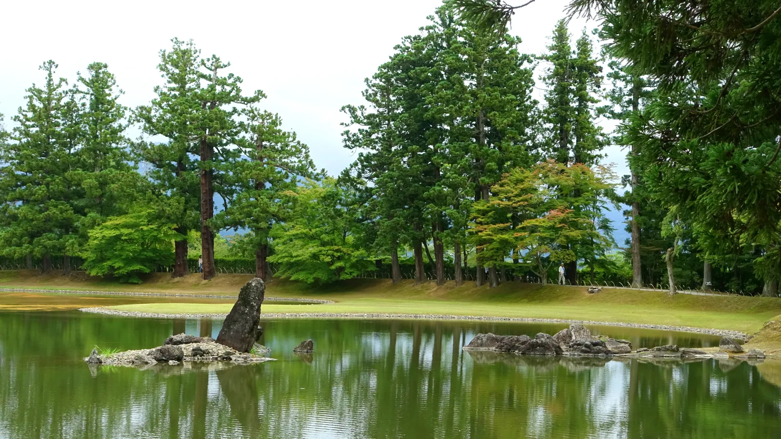 The Pure Land garden and Oizumi-ga-ike pond at Motsu-ji in Hiraizumi, with standing stones reflected in still water