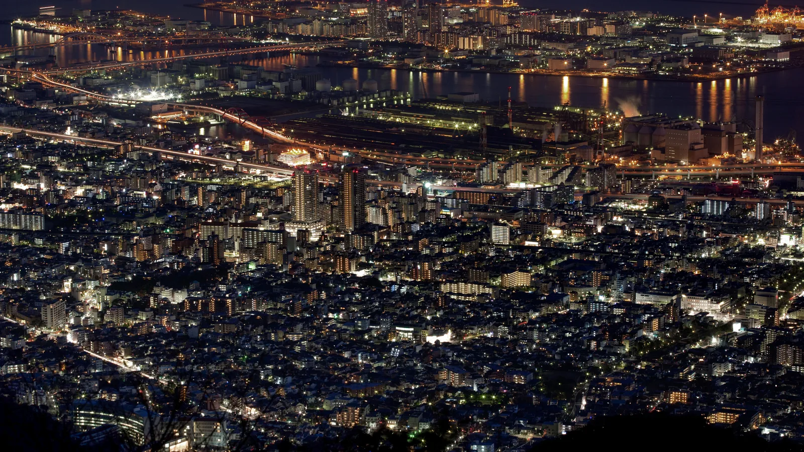 The night view of Kobe seen from the Rokko hills, the city's lights packed along the narrow band between the mountains and the sea
