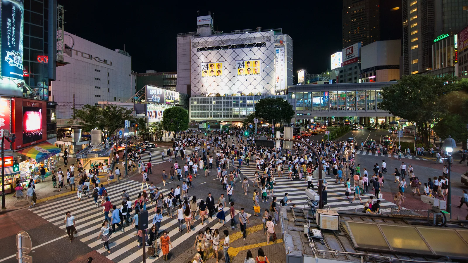Pedestrians crossing the Shibuya Scramble Crossing from all directions