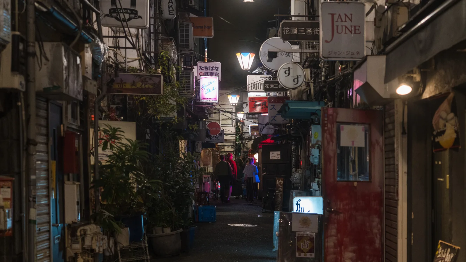 A narrow lantern-lit lane of tiny bars in Shinjuku's Golden Gai at night