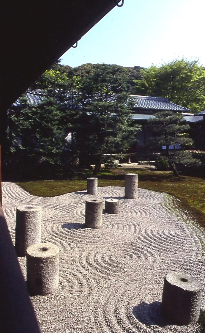Stout cylindrical stones arranged like a constellation across raked gravel in a dry Zen garden at Tofuku-ji