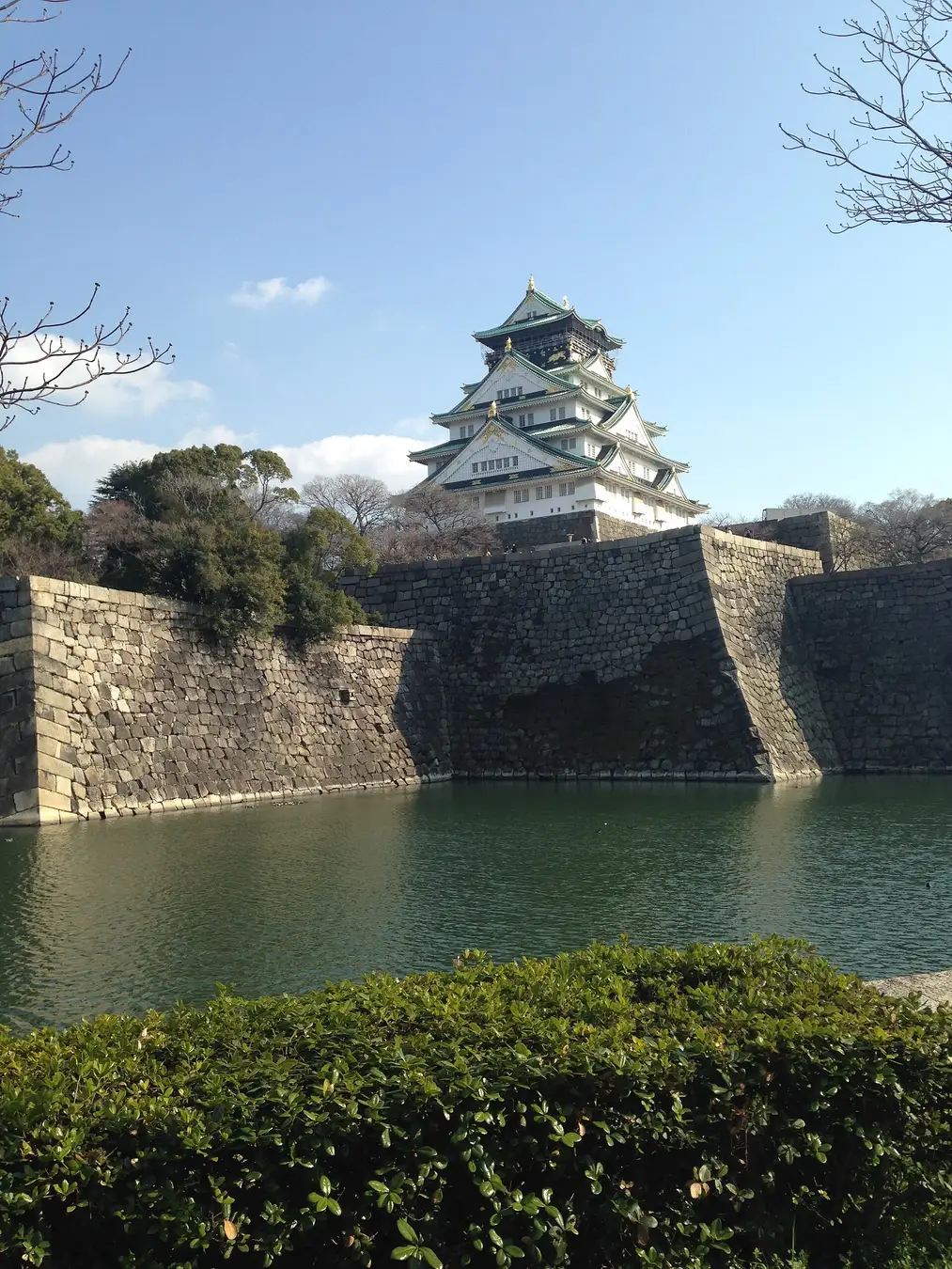 Osaka Castle's reconstructed keep rising above its moat and original stone walls