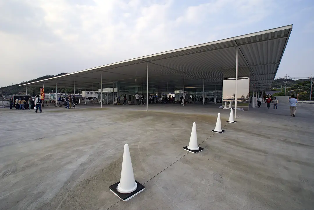 The thin-roofed Naoshima ferry terminal at Miyanoura port, sculptural white cones set across the open concrete plaza
