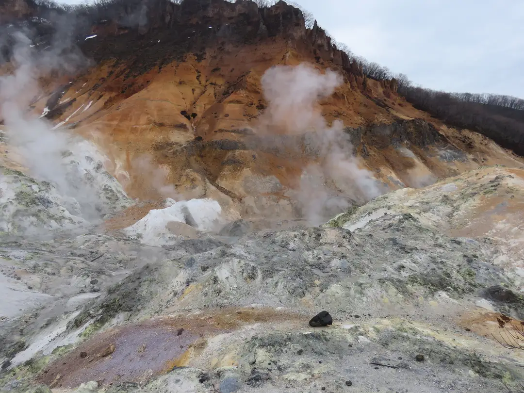 Steam rising from the orange and sulphur-streaked crater of Jigokudani, Noboribetsu's Hell Valley