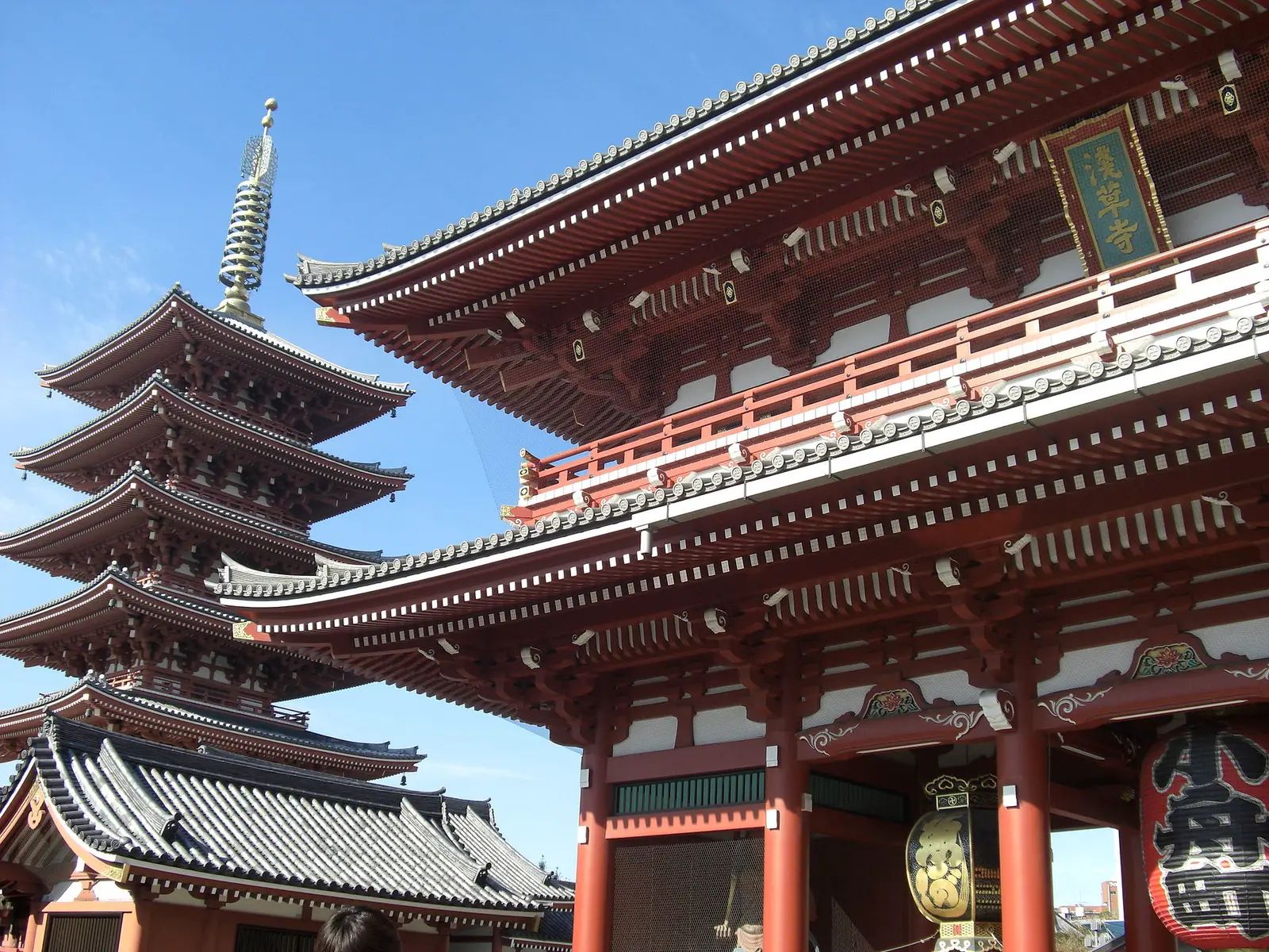 The five-story pagoda and Hozomon gate of Senso-ji temple against a blue sky in Asakusa, Tokyo