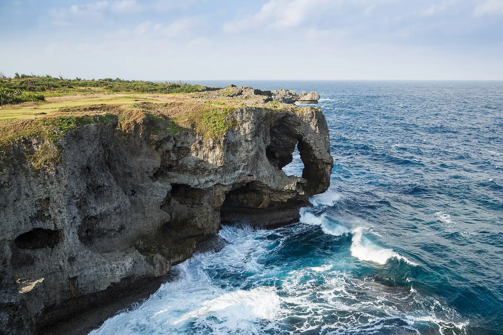 The coral cliff of Cape Manzamo standing above the deep blue sea, Onna, Okinawa