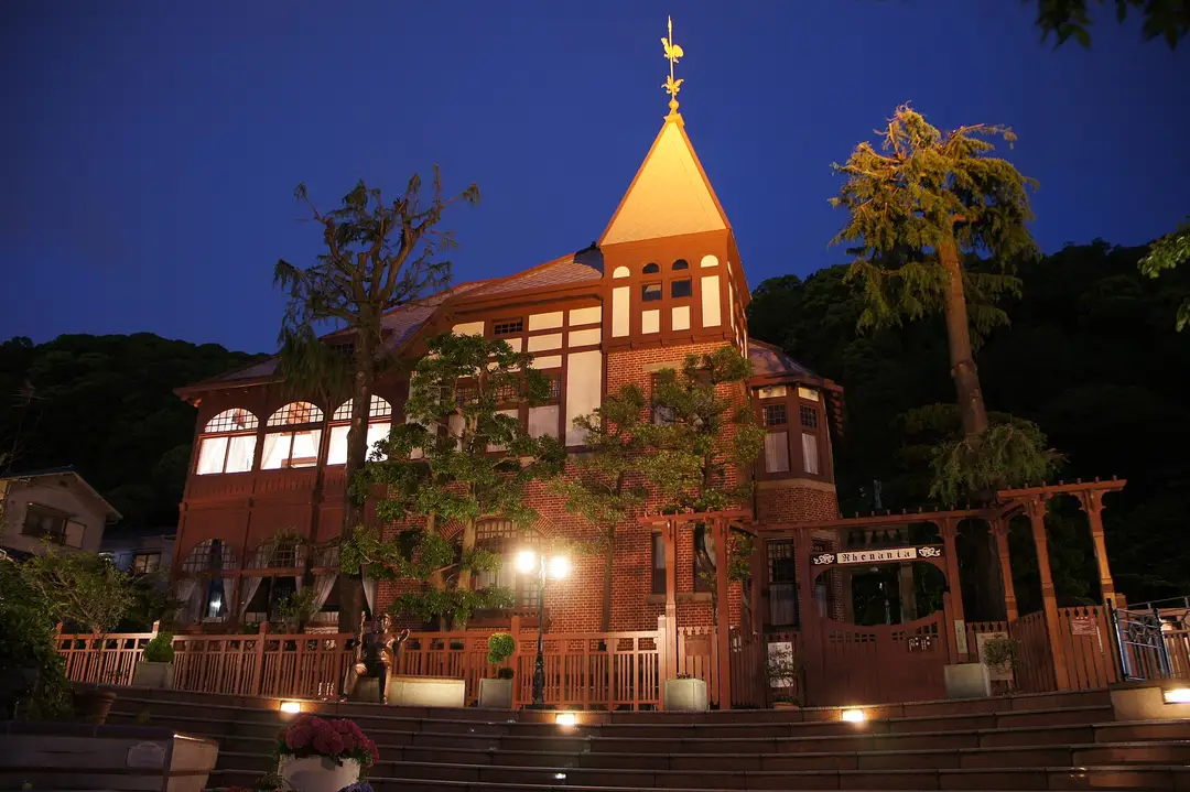 The Weathercock House in Kobe's Kitano district, lit up at dusk