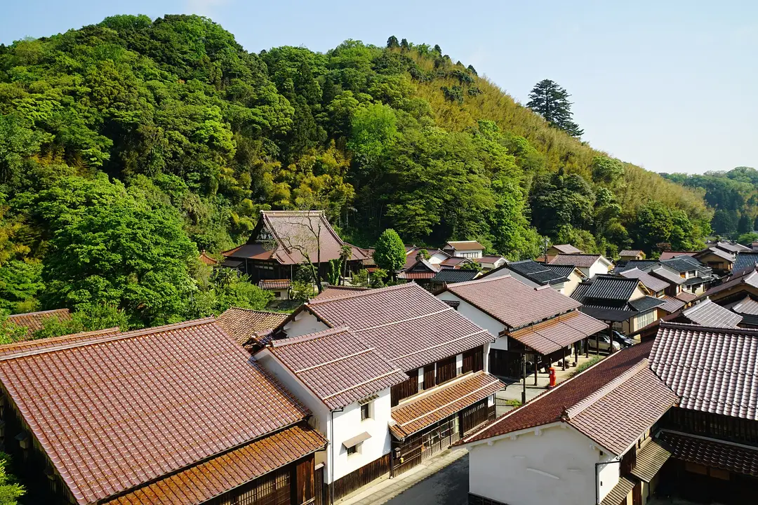 The preserved old town of Omori in the Iwami Ginzan silver-mine valley, its tiled roofs nestled deep among green forested hills