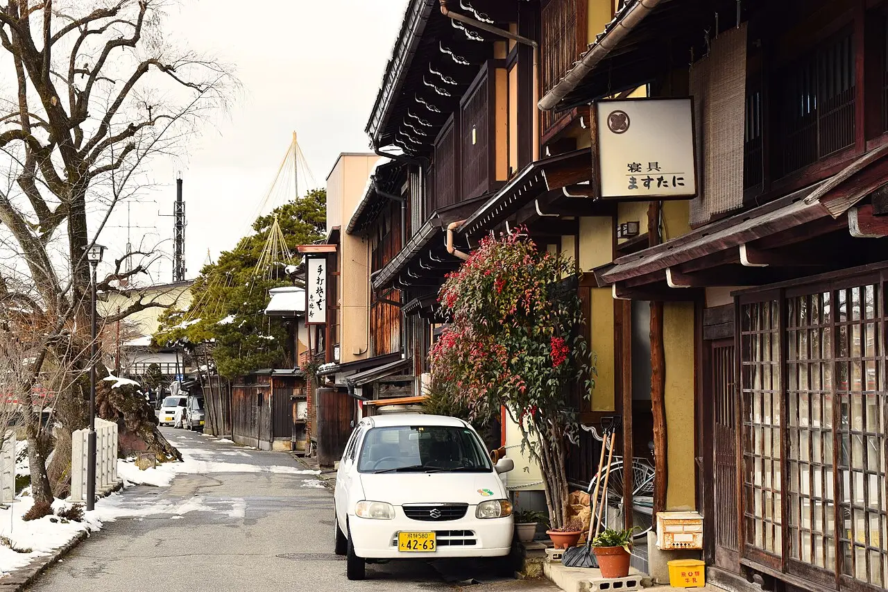 A quiet old-town street of wooden machiya in Hida-Takayama, in the Japan Alps, under light snow