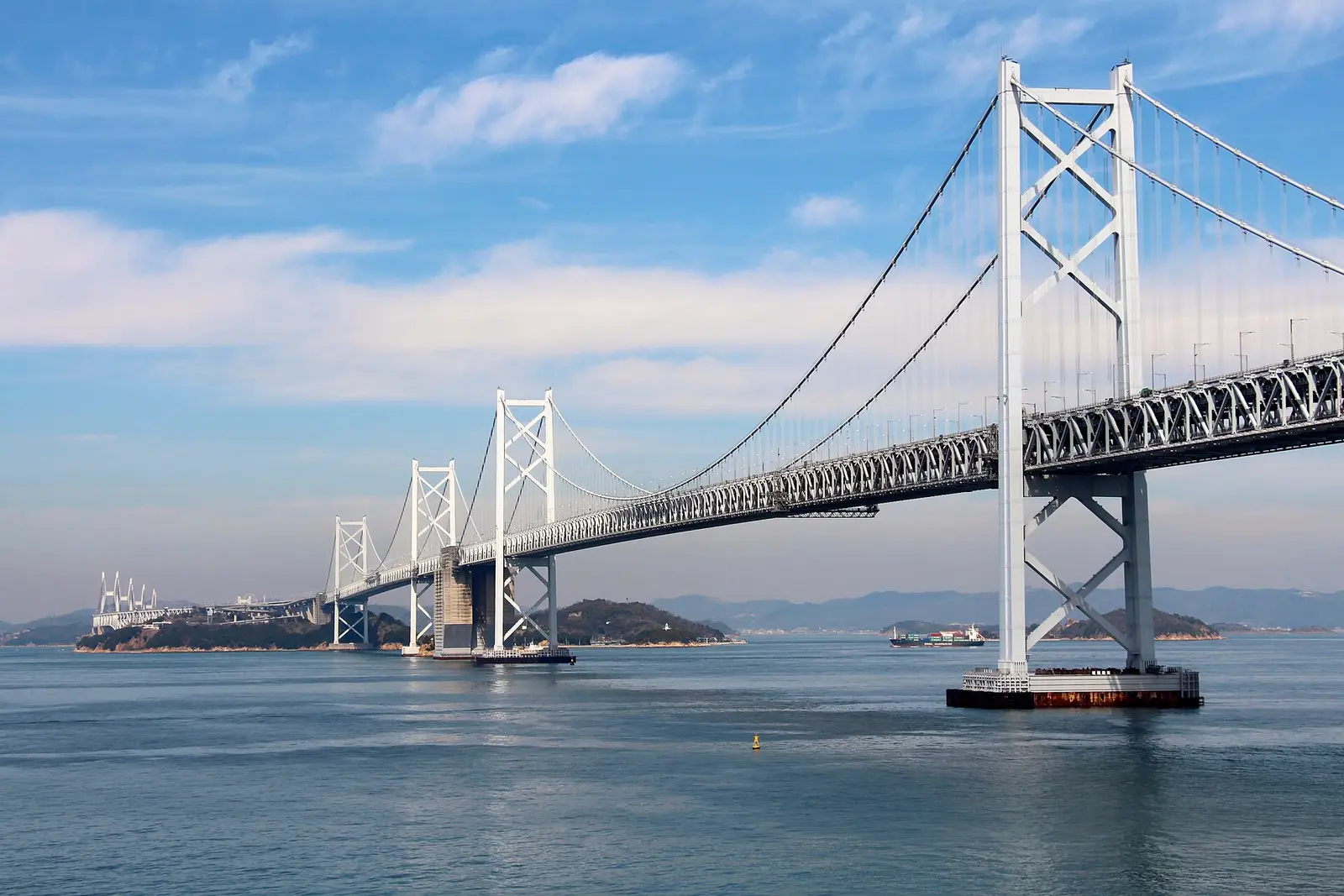 The white towers of the Great Seto Bridge striding across the calm Seto Inland Sea between scattered islands, the rail-and-road crossing that carries you onto Shikoku from Okayama