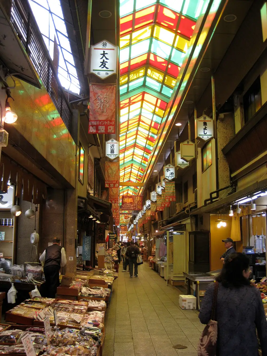 The covered shopping arcade of Nishiki Market in Kyoto, lined with food stalls